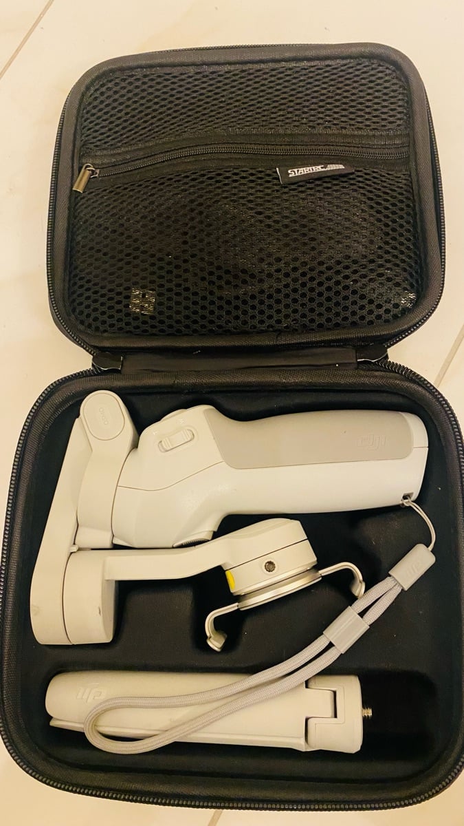 DJI OSMO 4 handheld gimbal with a hard case - Image 1